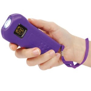 Purple Trigger stun gun in womans hand