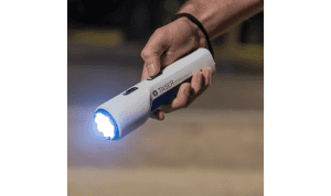 taser strikelight in a persons hand shining the light